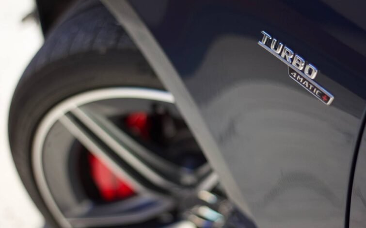 Primer plano desenfocado de la insignia "Turbo 4MATIC+" sobre el guardabarros delantero derecho del CLA 45 S.